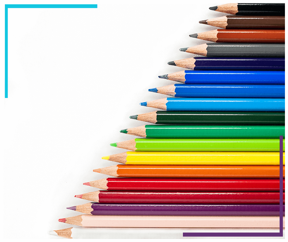 Many different colours of pencil crayons sit on a white backdrop, arranged diagonally